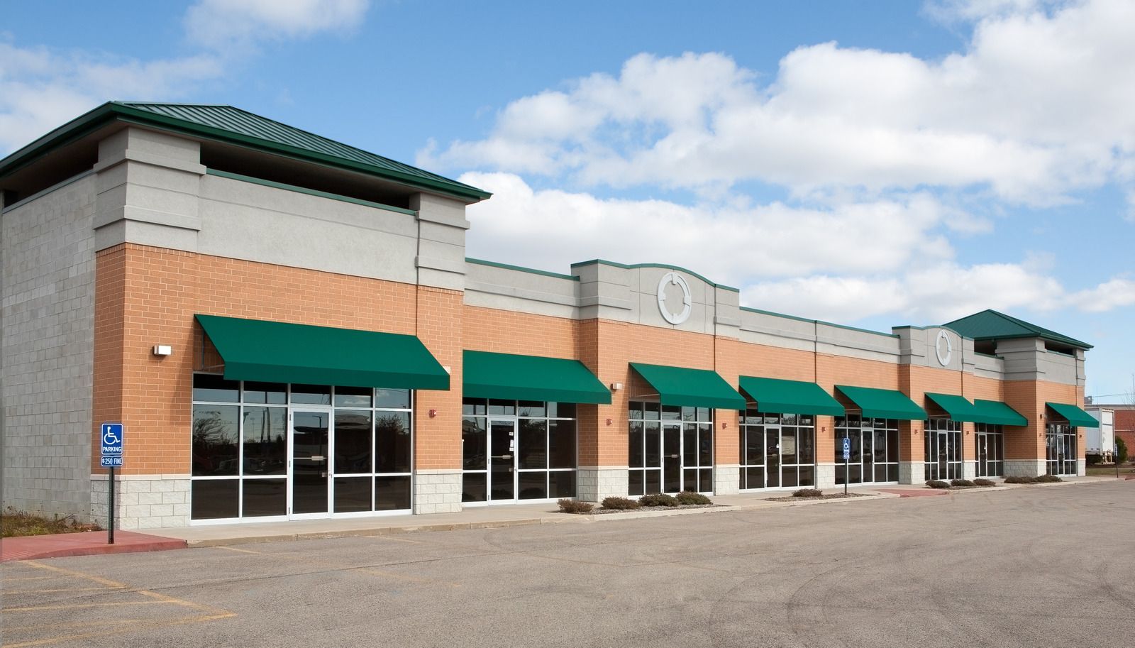 Stone-clad commercial property with entrance archway